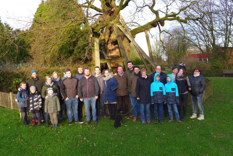 Erwachsene und Kinder stehen zusammen für ein Gruppenbild.